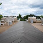 long commercial deck path leading to outdoor sitting area.