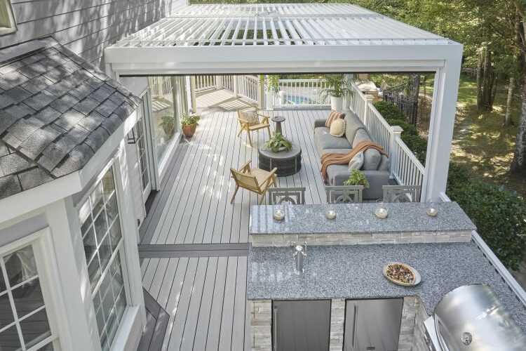 Outdoor living space with deck, kitchen, and pergola