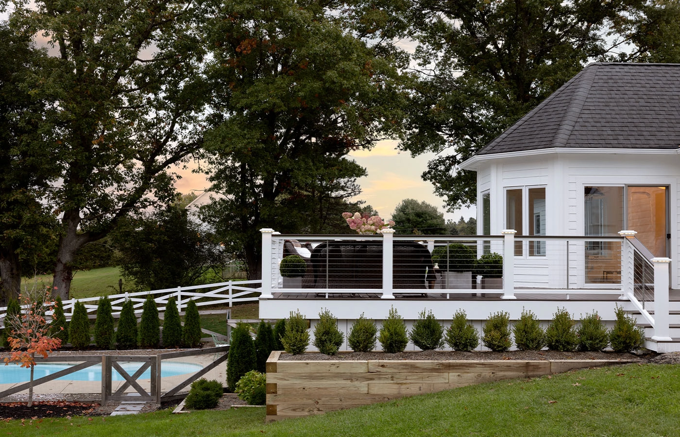 elevated-deck-with-wire-railing-and-outdoor-furniture-and-a-pool