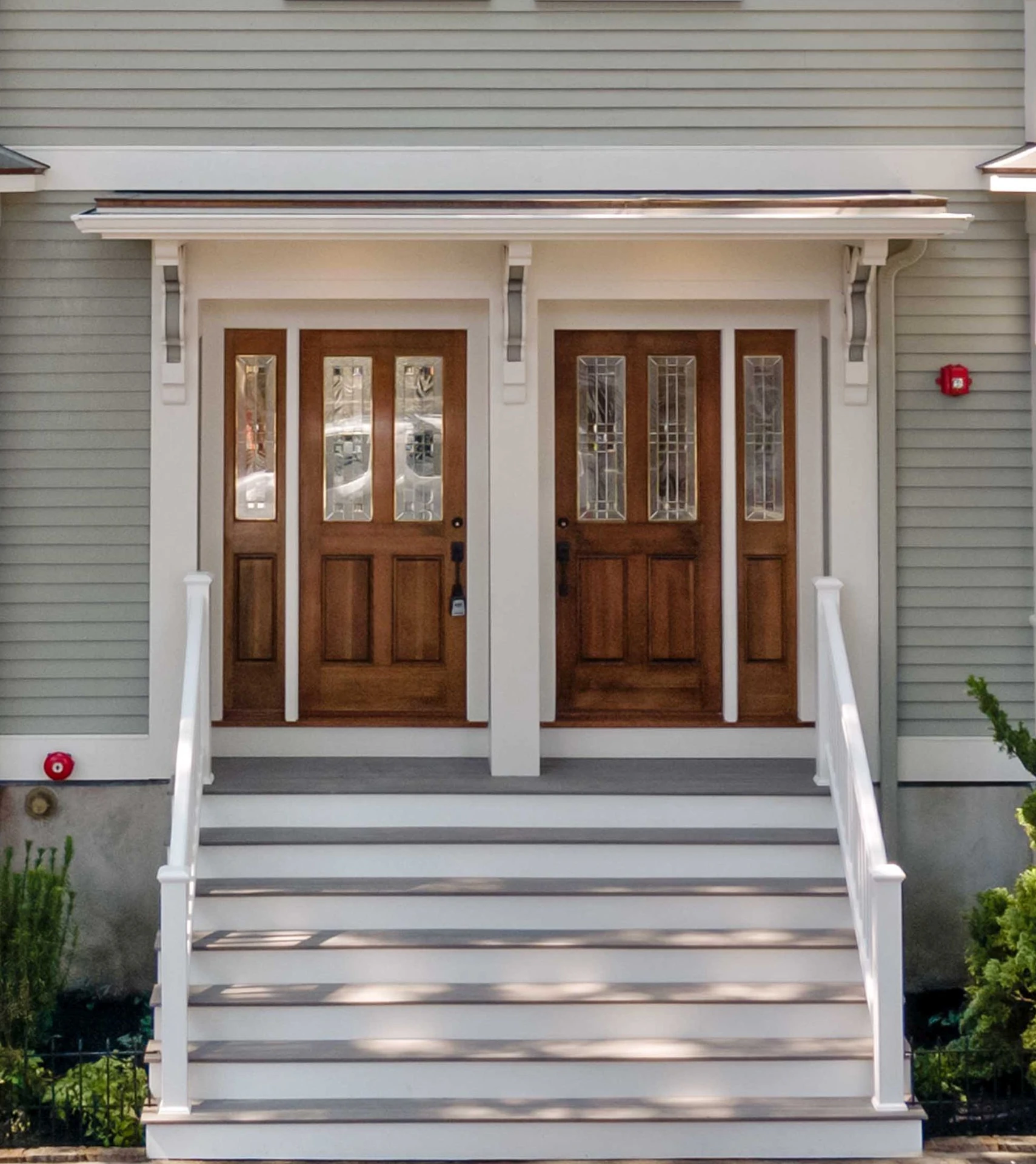 flat-roof-bracket-portico-with-white-railing