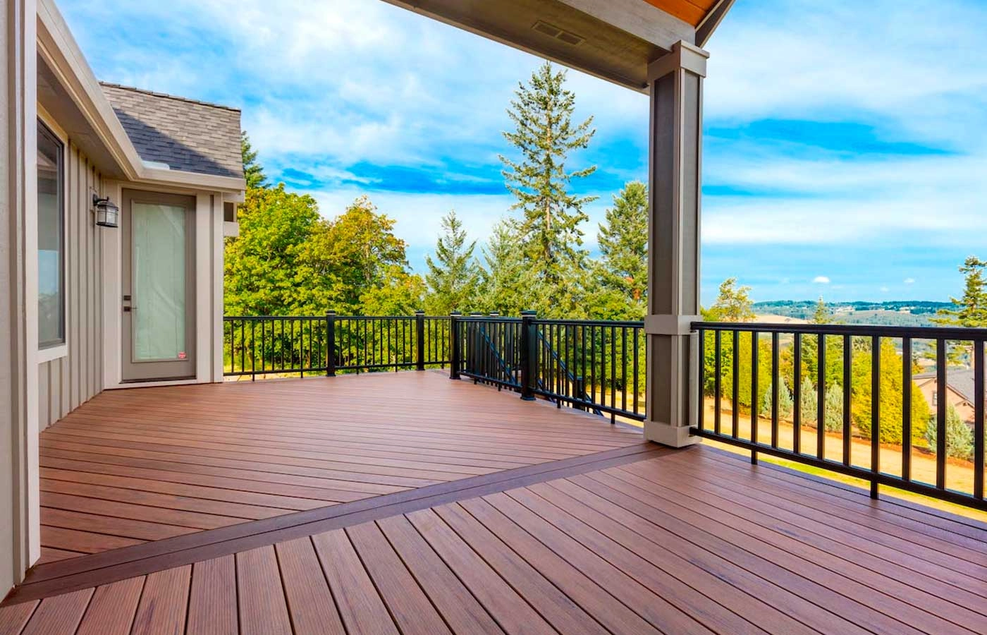 hard-wood-decking-with-black-aluminum-railing-featuring-clear-sky-view
