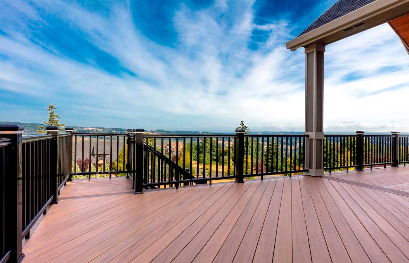 hard-wood-decking-with-black-railing-and-blue-clear-sky-view