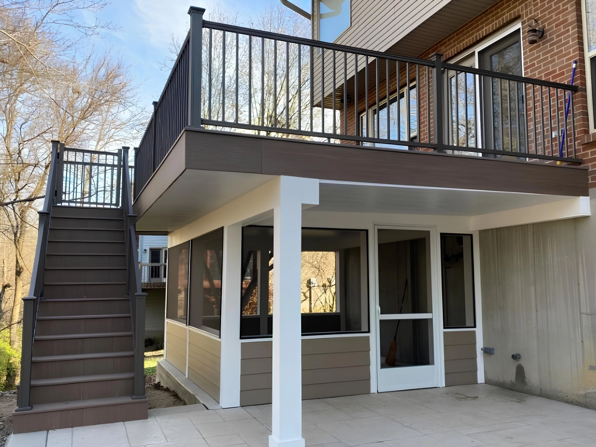 screen-porch-on-under-pvc-decking-with-black-aluminum-railing-with-a-small-entrance-gate