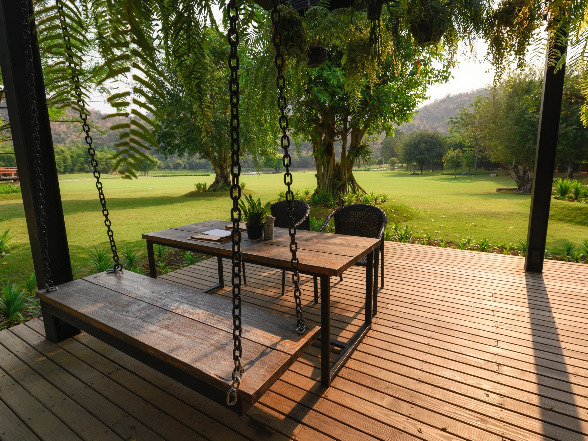 sun-kissed-wooden-deck-and-chair-featuring-forest-background